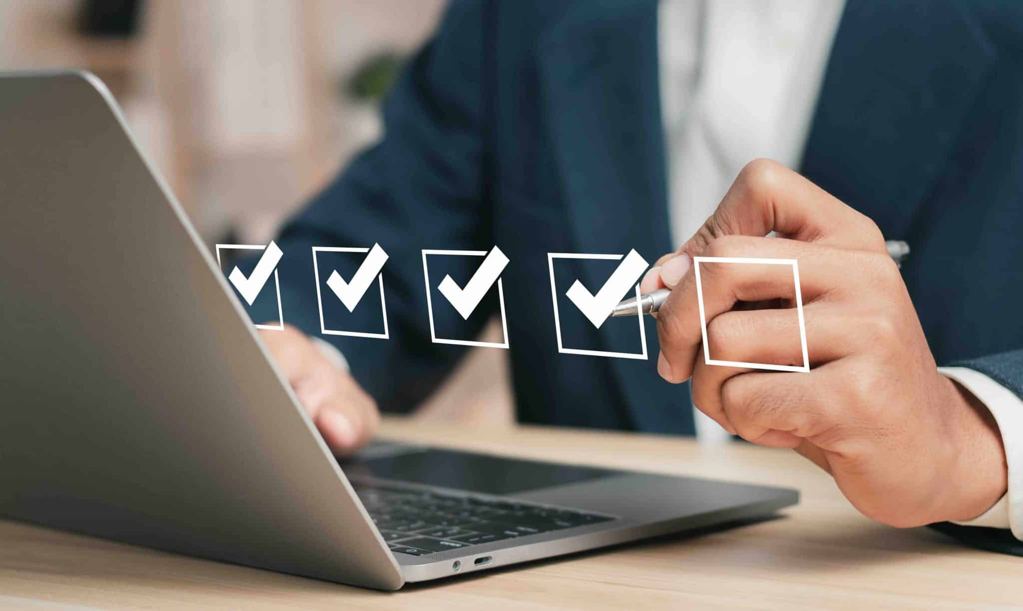 Checklist concept. Businessman using laptop. Checking mark on checkboxes.